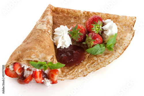 Rolled pancakes with strawberry, sweet cream and mint