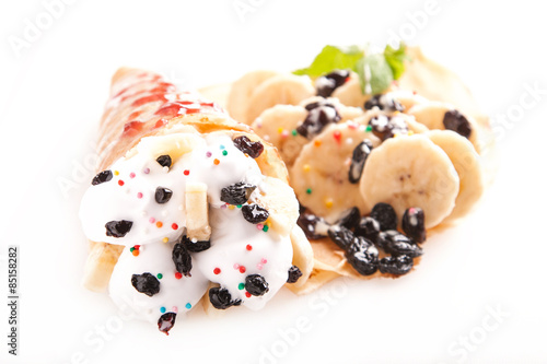 Rolled pancakes with sweet cream and fruits