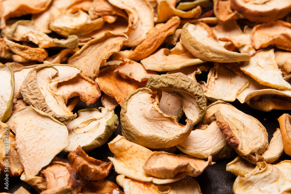 slices of dried apples as background on black slices of dried apples as background on black