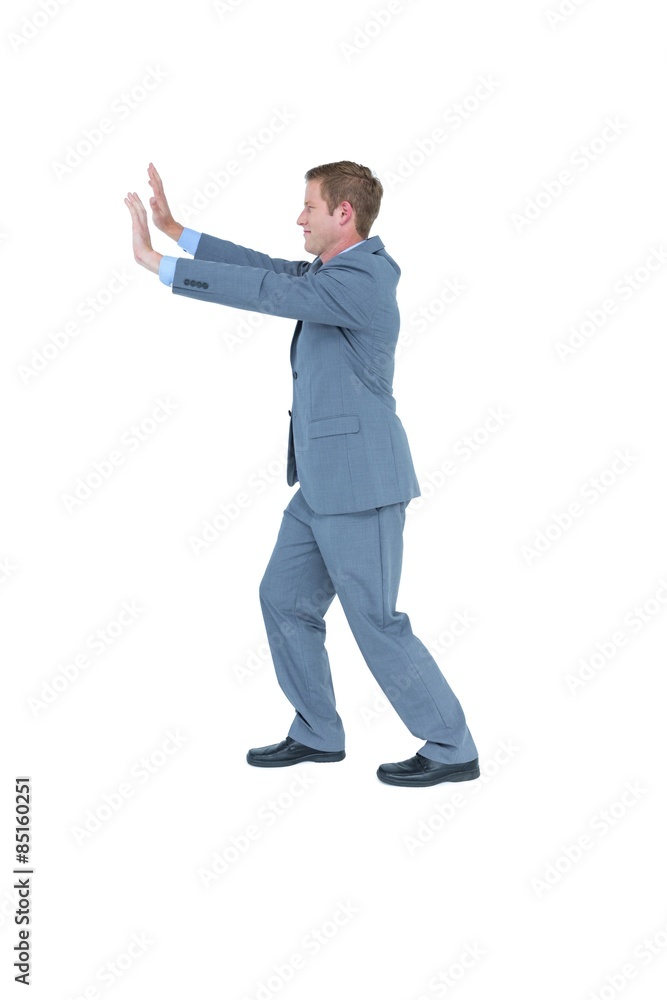 Businessman standing and pushing with hands Businessman standing and pushing with hands
