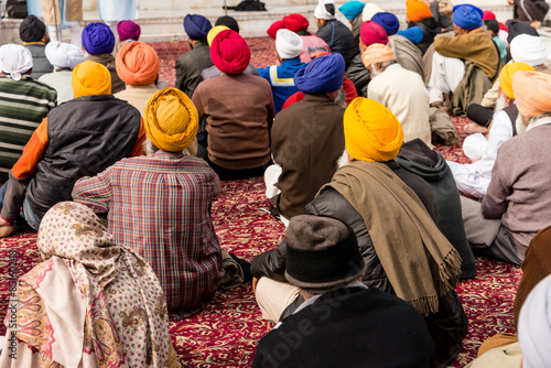 Sikh pilgrims sitting at prayer at the Golden Temple in Amritsar