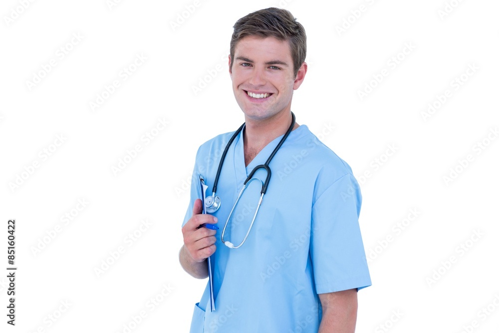 Young nurse in blue tunic smiling at the camera Young nurse in blue tunic smiling at the camera