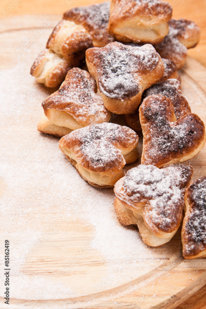 bakery hearts from split pastry with sugar powder on wooden bakery hearts from split pastry with sugar powder on wooden