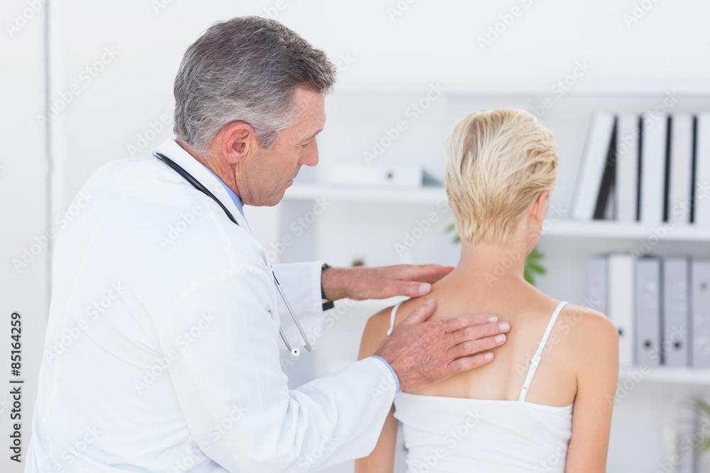 Fototapeta premium Doctor examining his patient back 