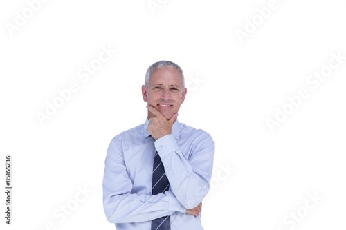 Smiling businessman with head on hand