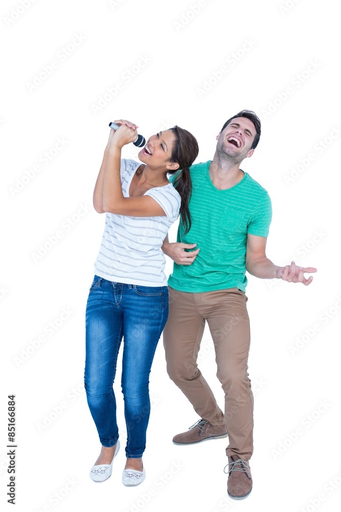 Friends singing in a microphone and playing air guitar Friends singing in a microphone and playing air guitar