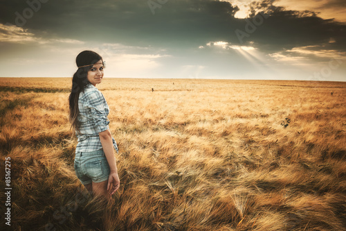 Young woman on summer field