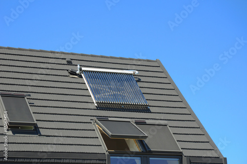 Solar water panel heating, skylights snd roof window solar blinds on new house roof 