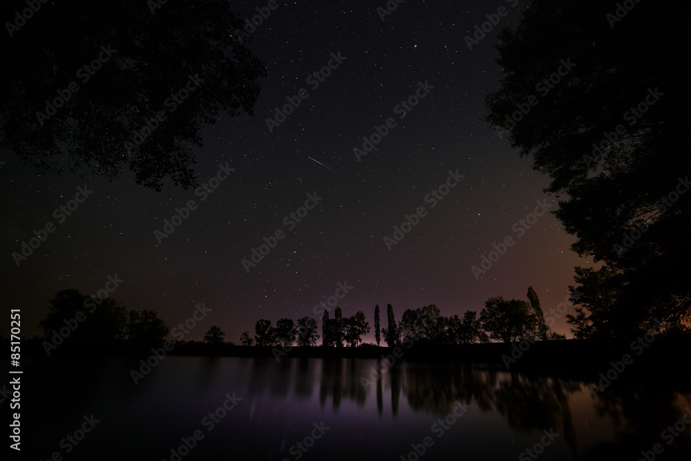Smooth surface of forest lake on a background of the night sky Smooth surface of forest lake on a background of the night sky