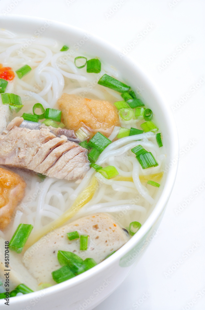 Bun cha ca or Vietnamese rice vermicelli with grilled fish and herbs on a white background Bun cha ca or Vietnamese rice vermicelli with grilled fish and herbs on a white background