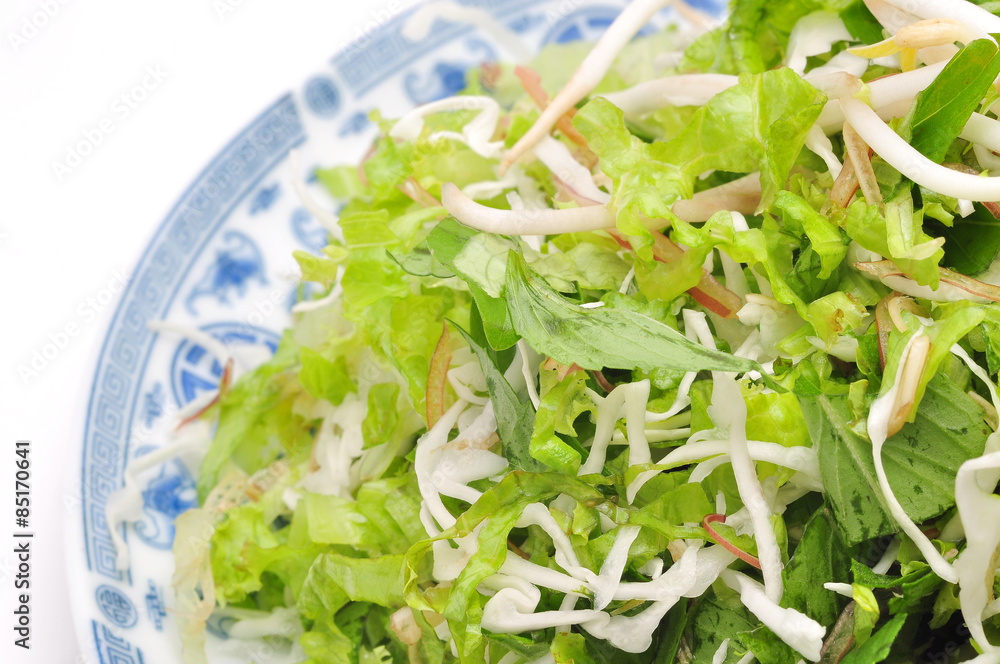 Dish of Vietnamese herbs on a white background Dish of Vietnamese herbs on a white background