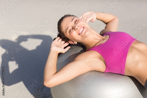 Fit woman stretching on exercise ball