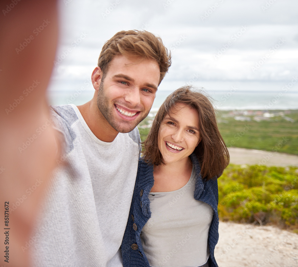 Couple taking a selfie outdoors on a nature trail Couple taking a selfie outdoors on a nature trail