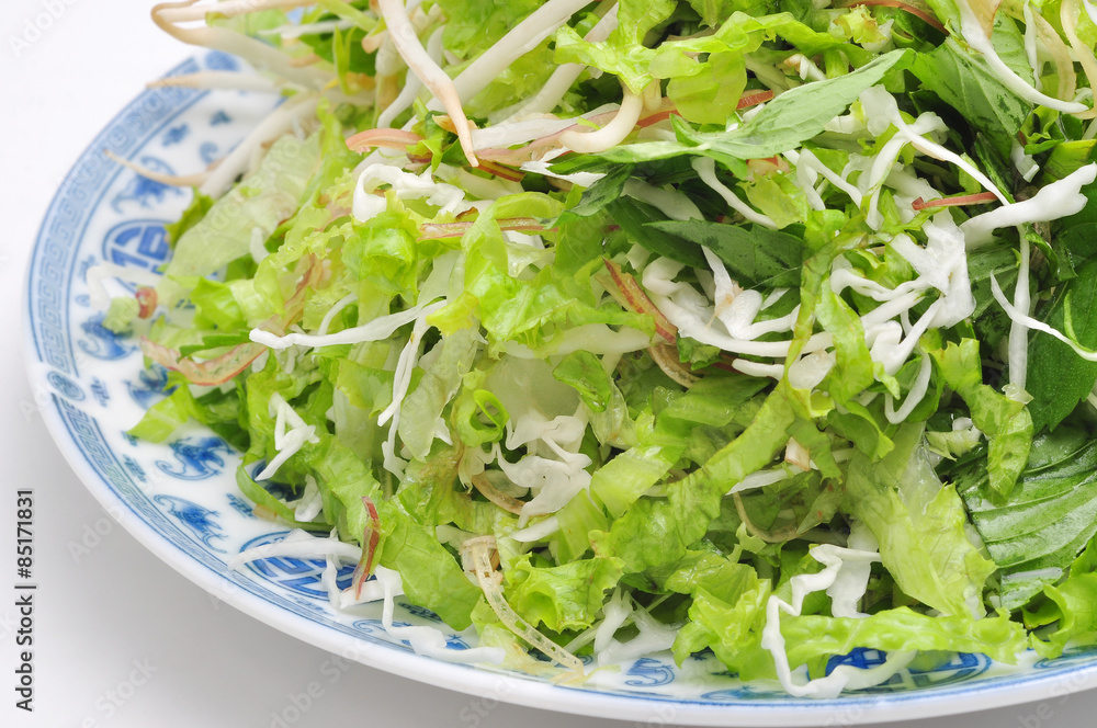Dish of Vietnamese herbs on a white background Dish of Vietnamese herbs on a white background