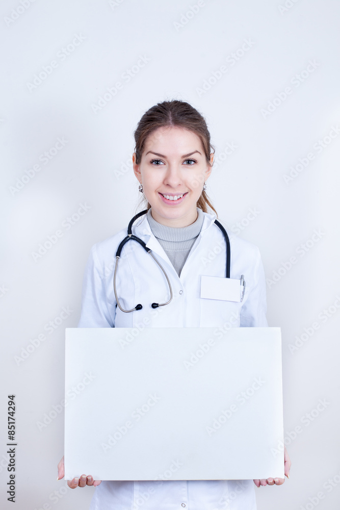 Smiling doctor holding a banner for advertising Smiling doctor holding a banner for advertising