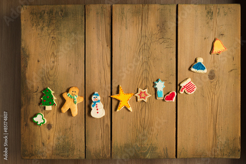 Sweet cookies arranged in row on wooden table