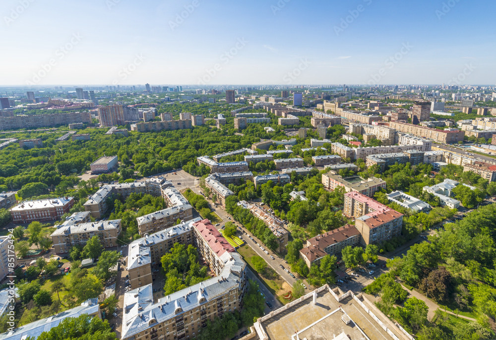 View of Moscow modern residential quarters at sunset on top of the roof of a tall building