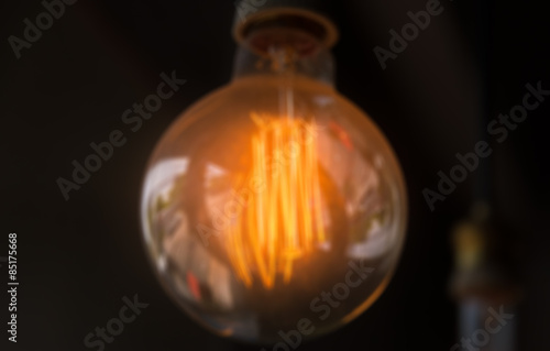 Blur of orange lamp in dark room