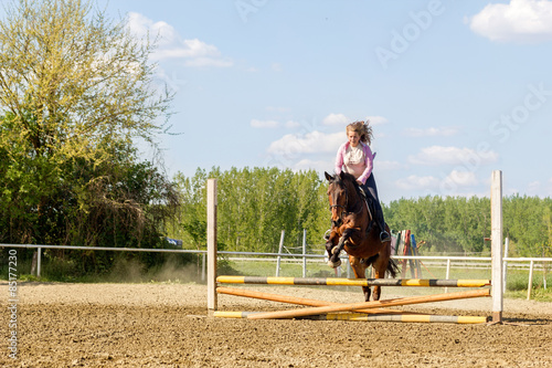 Beautiful girl riding a purebred horse