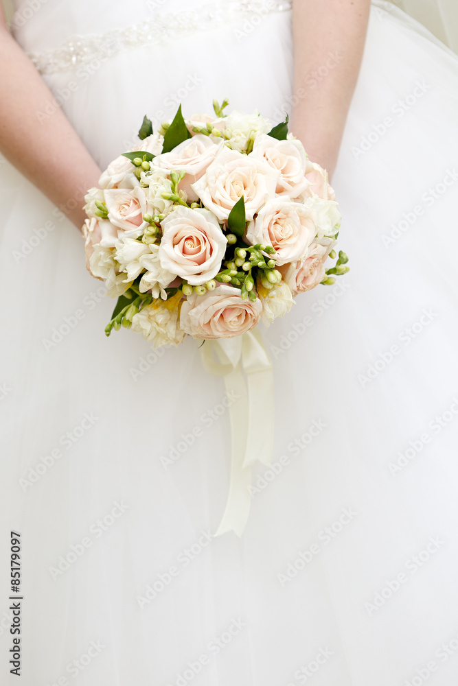 The bride at a wedding holding a bouquet of flowers.