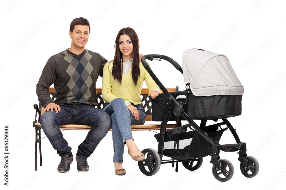 Young parents sitting on a wooden bench Young parents sitting on a wooden bench