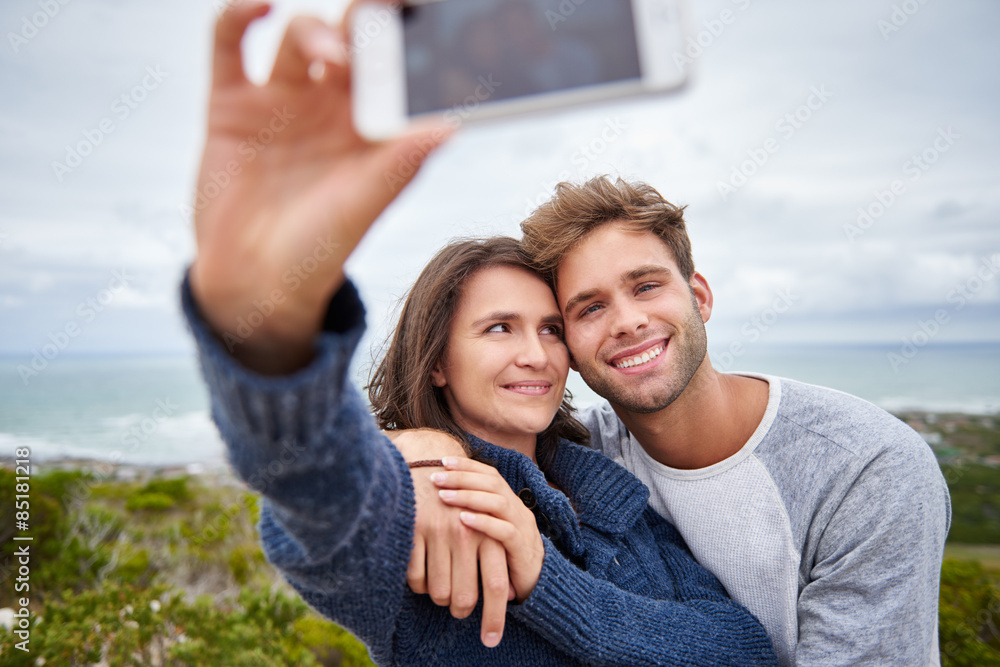 Young woman smiling at her boyfriend while taking a selfie Young woman smiling at her boyfriend while taking a selfie