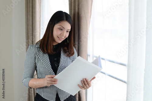 young attractive asian business woman with briefcase