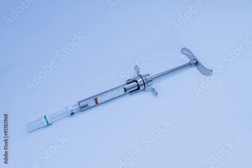 Dental syringe isolated on blue background