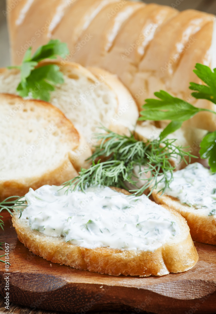 Bruschetta with white sauce and herbs, selective focus Bruschetta with white sauce and herbs, selective focus