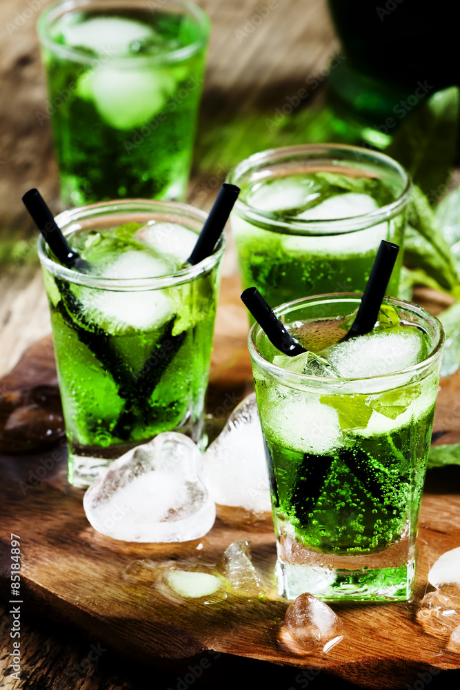 Green cocktail with tarragon, mint soda and ice, selective focus Green cocktail with tarragon, mint soda and ice, selective focus