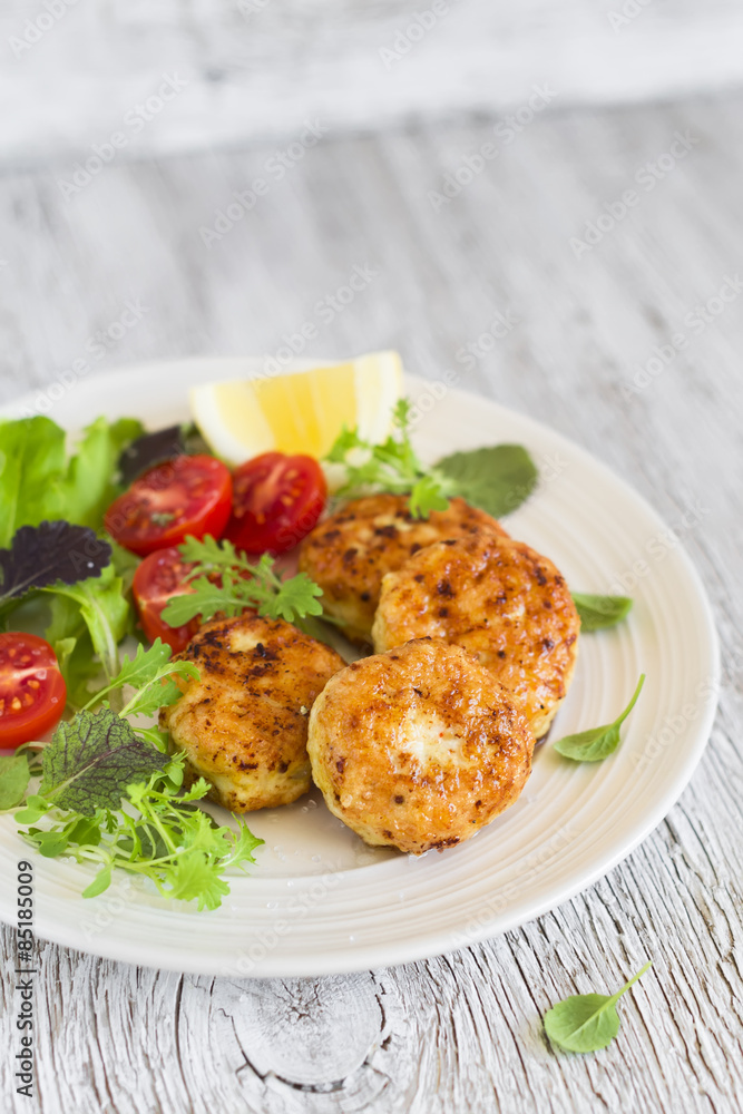 chicken cutlet with fresh vegetable salad in a vintage pan 