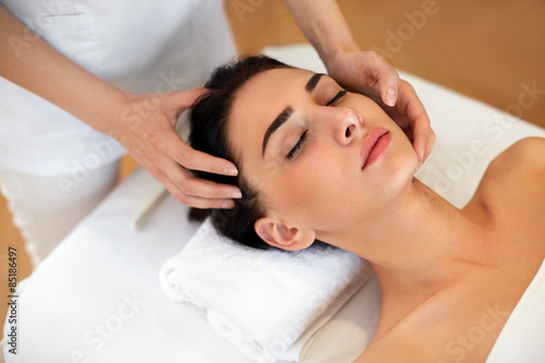 Beautiful Young Woman Getting a Face Treatment at Beauty Salon.