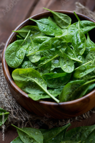 Close-up of spinach leaves in a wooden bowl  selective focus