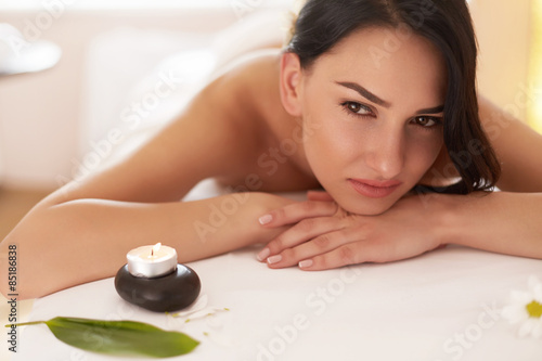 Spa Massage. Beautiful Brunette Gets Spa Treatment in Salon.