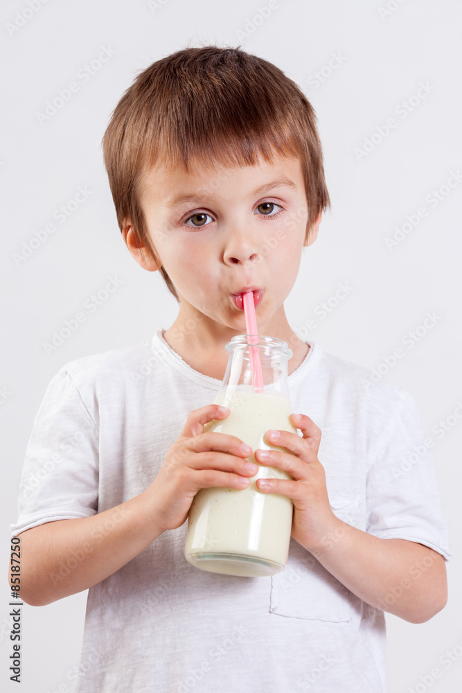Cute little boy, drinking milk, holding glass of milk, mustaches Cute little boy, drinking milk, holding glass of milk, mustaches
