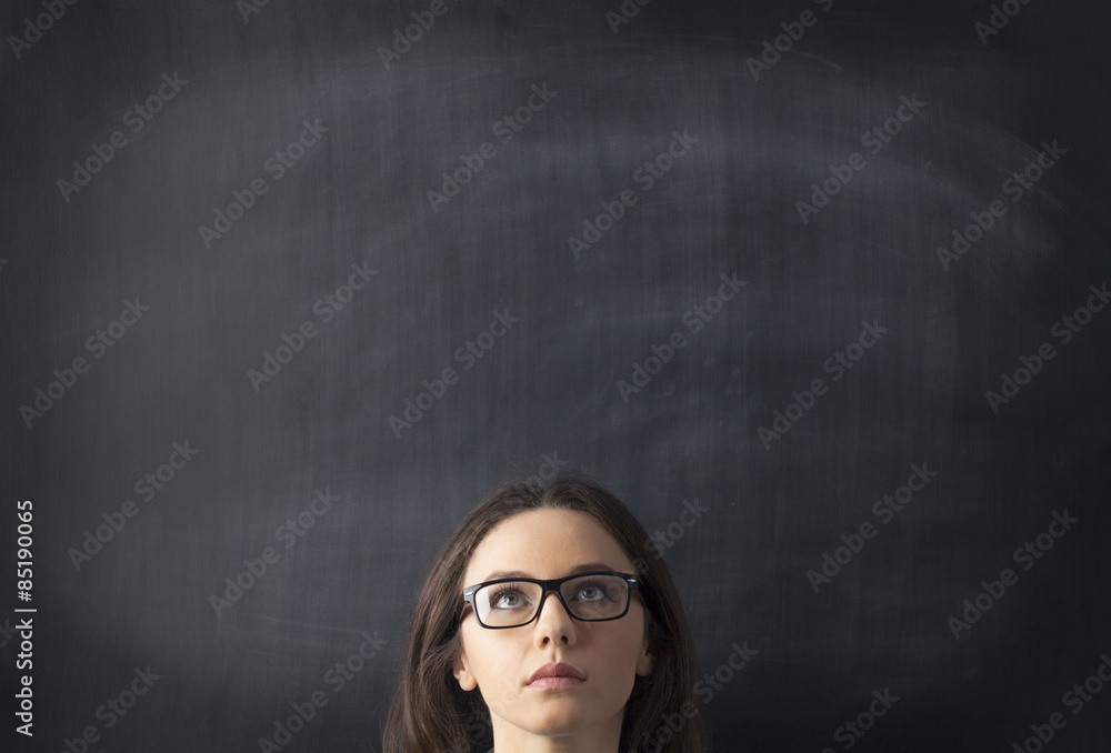 Young woman looking up with blackboard Young woman looking up with blackboard