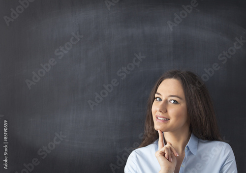 Businesswoman in front of blackboard © dragonstock
