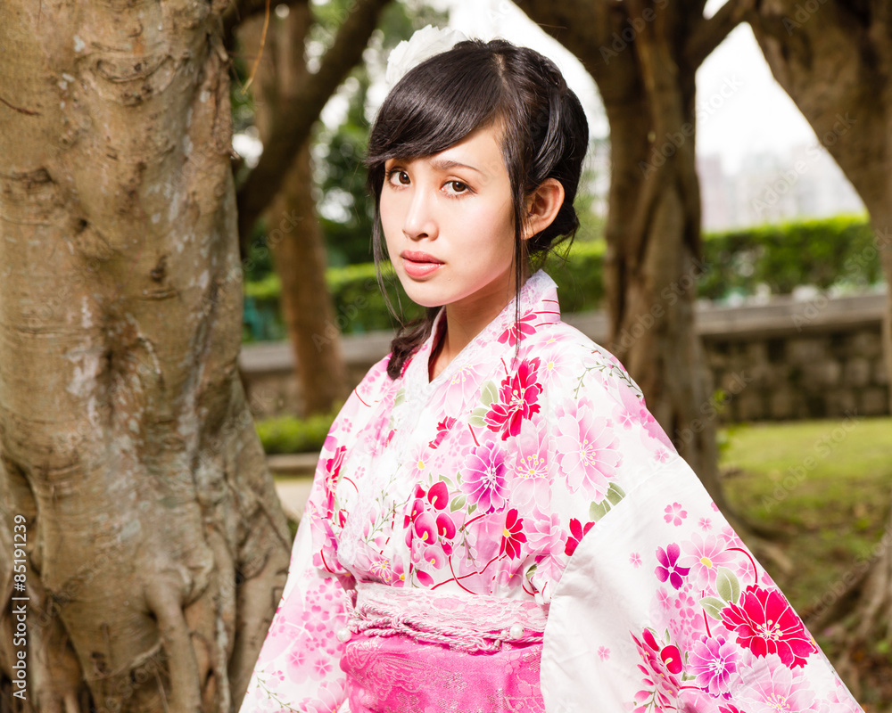 Asian woman in kimono in garden