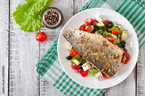 Tableau sur toile Baked seabass with Greek salad.