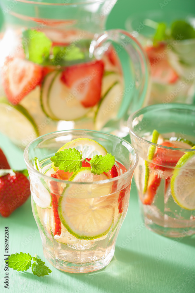 refreshing summer drink with strawberry cucumber lime in jar and refreshing summer drink with strawberry cucumber lime in jar and