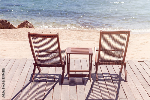 Two sitting place and table in a tropical beach © dechevm