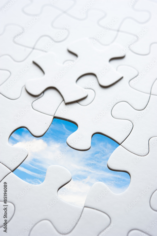 Jigsaw piece with sky in hole, conceptual image Jigsaw piece with sky in hole, conceptual image