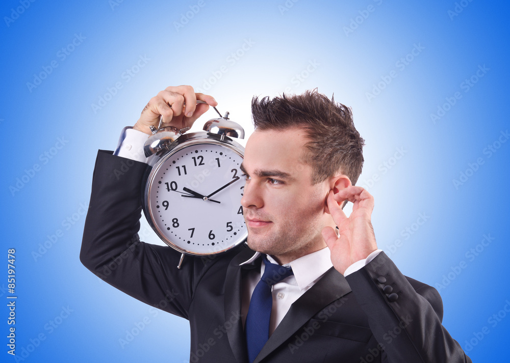 Businessman with clock against the gradient