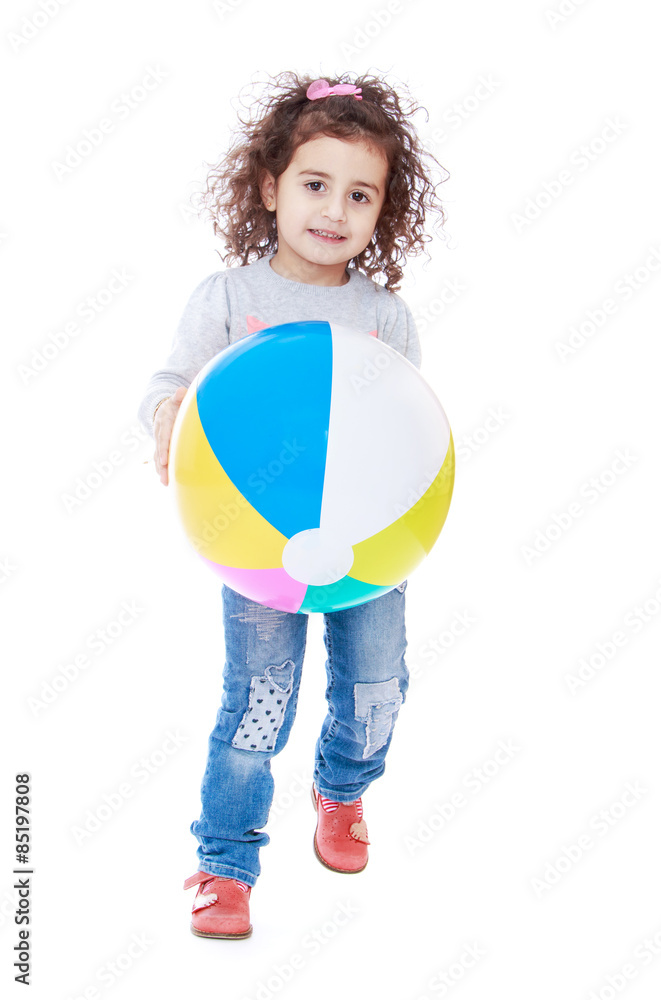 Fun curly-haired little girl playing ball Fun curly-haired little girl playing ball