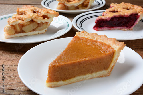 Fényképezés Closeup of four slices of pie on dessert plates