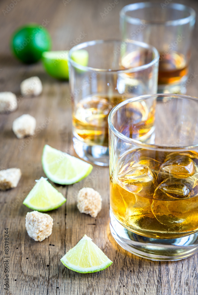 Glass of rum on the wooden background Glass of rum on the wooden background