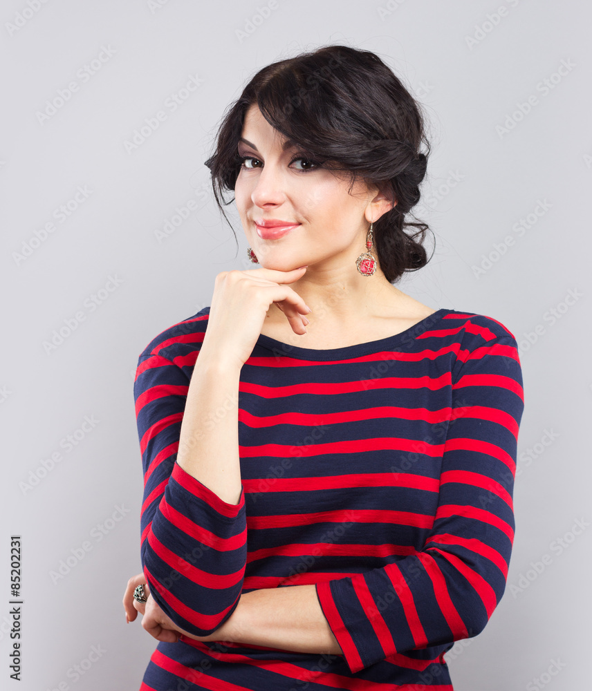 Beautiful brunette in a blue dress with red stripes. Fashion. Beautiful brunette in a blue dress with red stripes. Fashion.