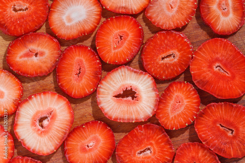Cut strawberries on wood board