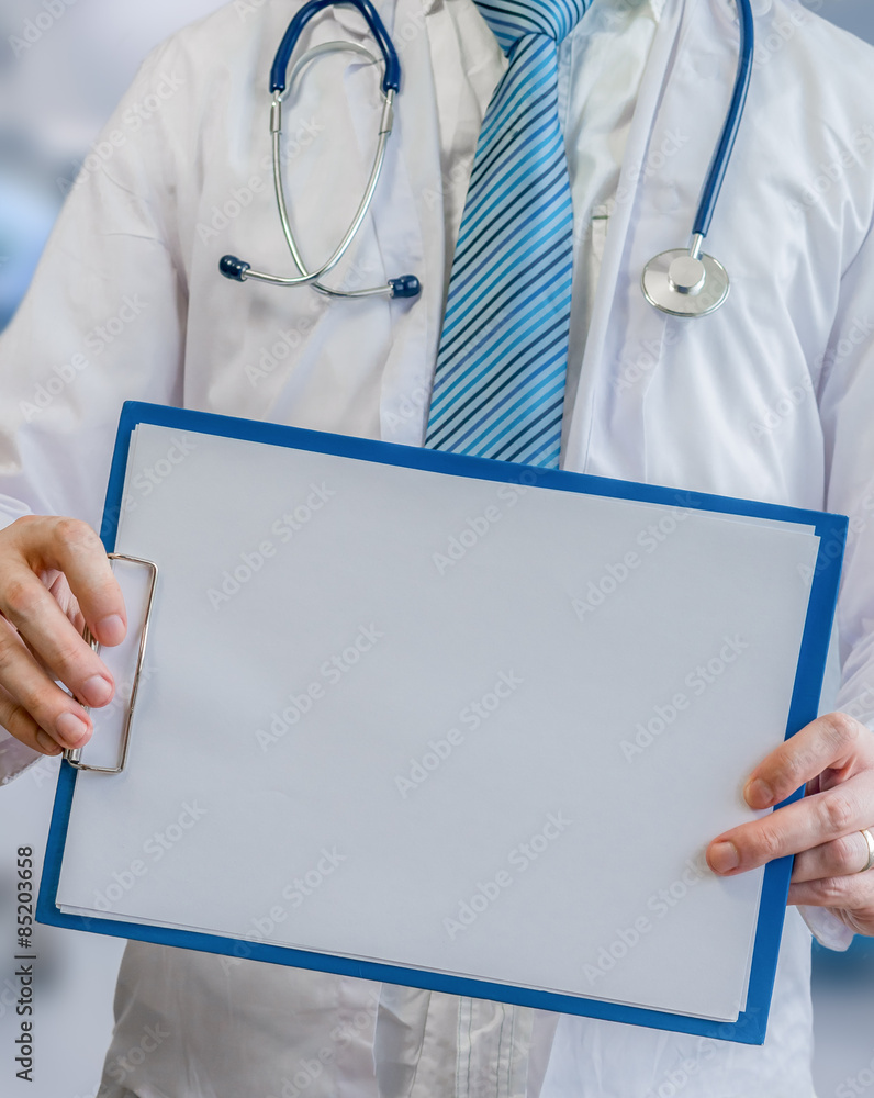 Doctor holds clipboard with empty sheet of paper as frame Doctor holds clipboard with empty sheet of paper as frame