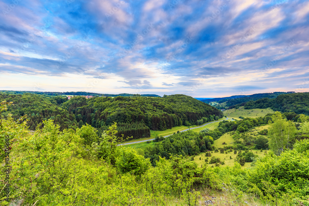Stunning Summer Evening Landscape in the rural Countryside of Bamberg. Lovely green and blue colors near a picturesque country road